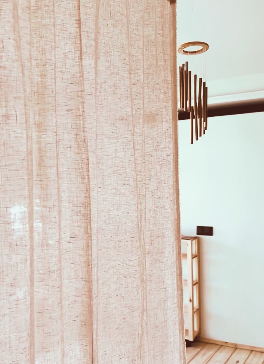 A linen curtain and a bamboo wind chime at the edge of the practice room