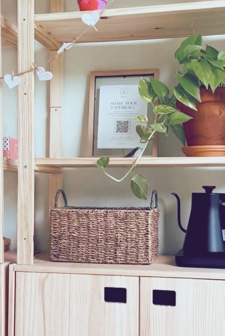 Pine shelves with a basket, a trailing plant and the tea kettle