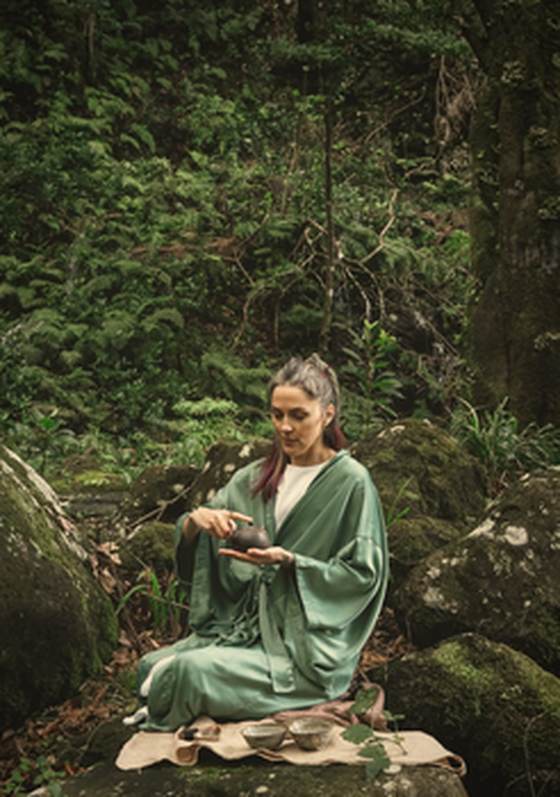 Olesea Rusu preparing tea on a mossy rock in the Laurisilva forest