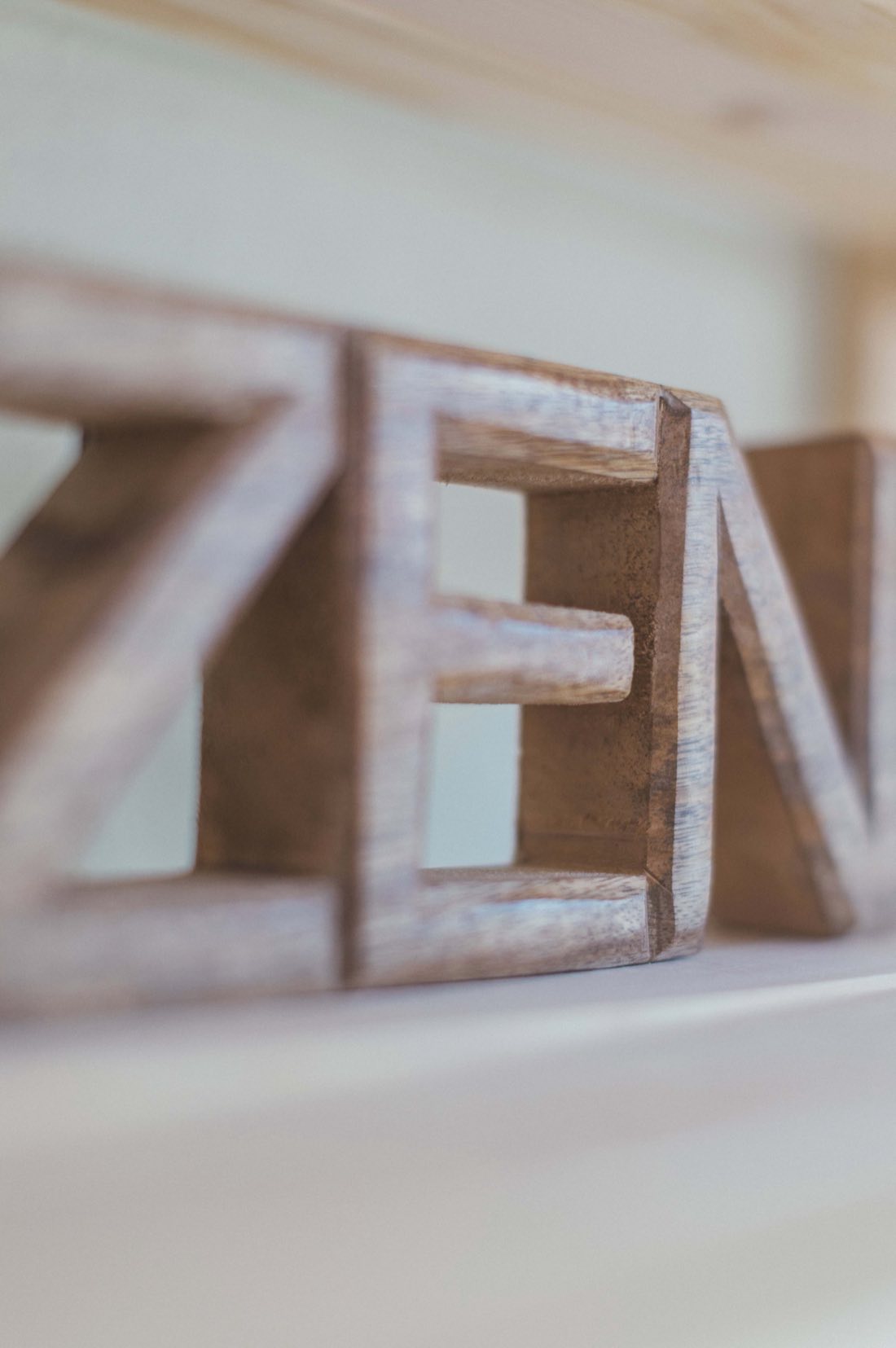 The word ZEN carved in wood, resting on a shelf in the studio